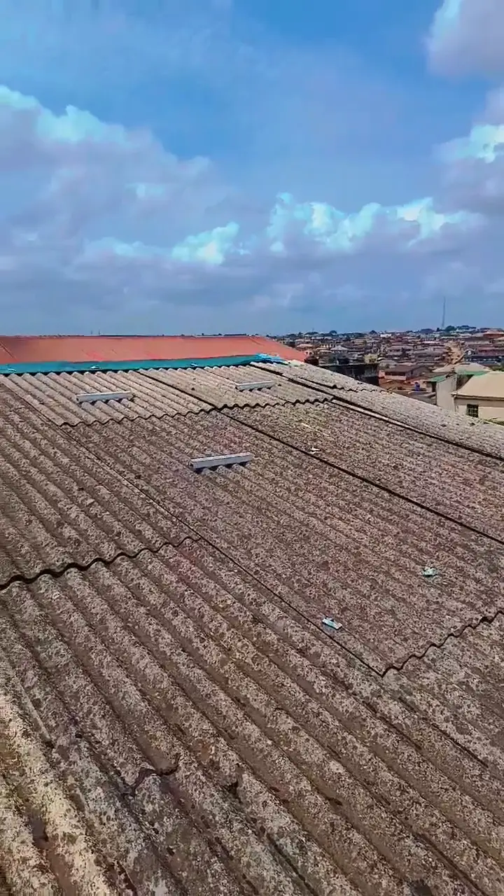 The crew installing the new panels on the hotel's corrugated roof.