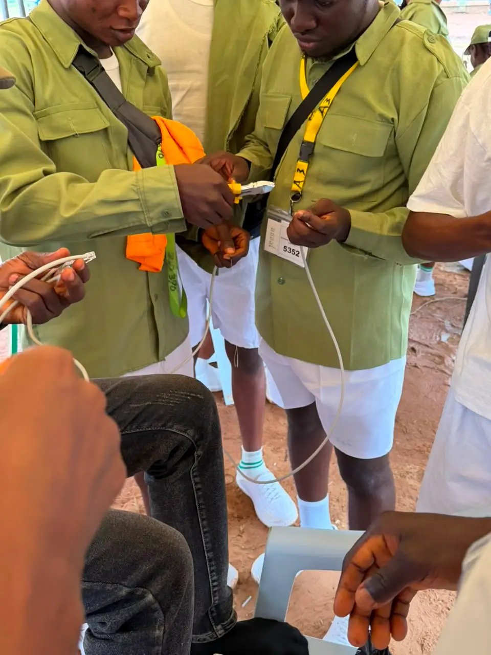 A corps member wiring a circuit during a practical class.