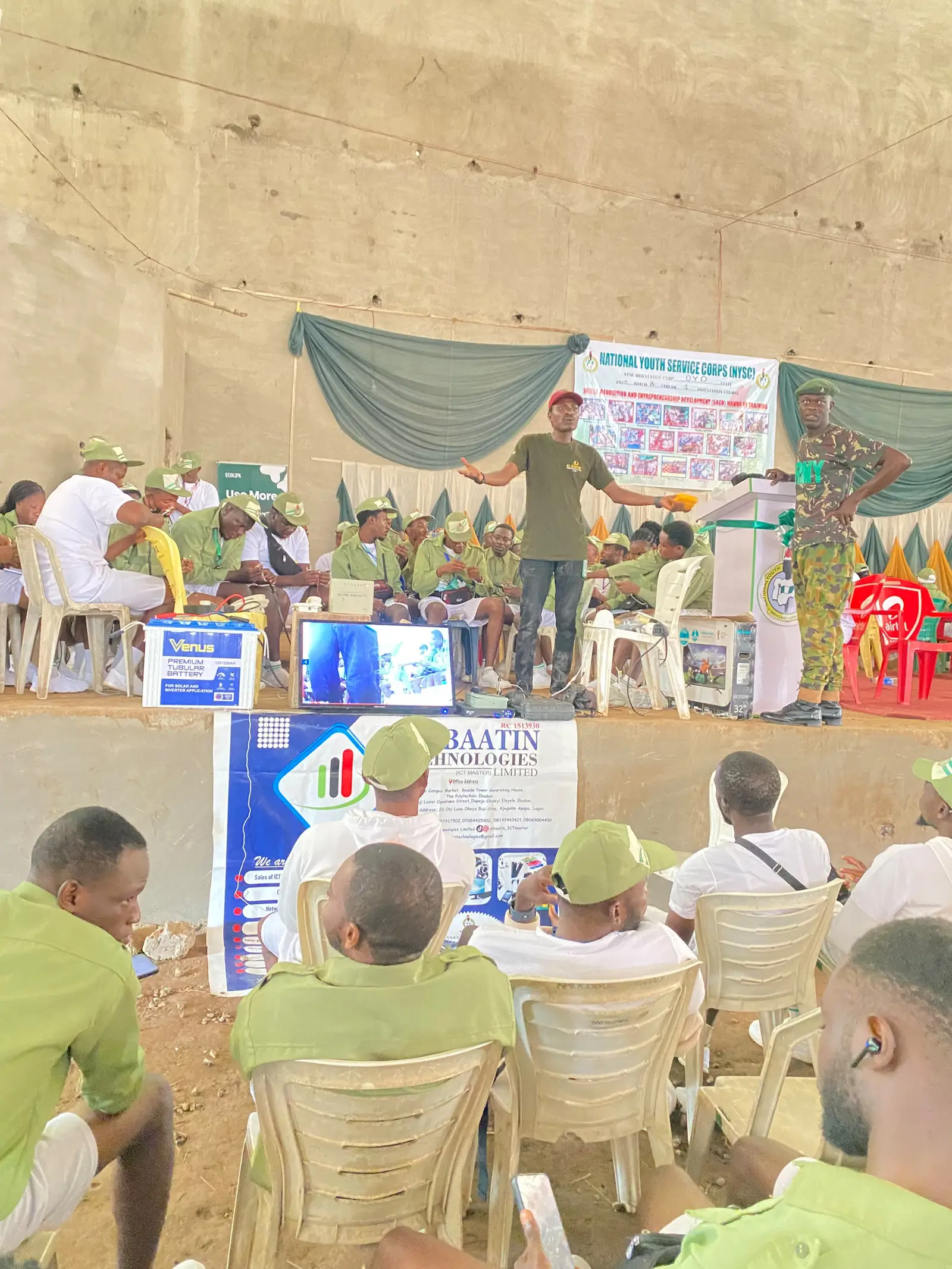 Al-Baatin addressing a hall full of corps members at NYSC orientation camp.